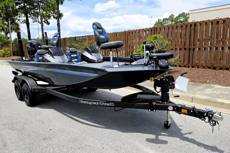 Slide: The Image of 2026 Ranger RT188P fishing boat on trailer, parked outdoors, featuring sleek design and modern equipment. - 4