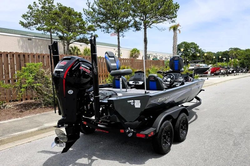 Slide: The Image of 2026 Ranger RT188P boat with Mercury engine, parked outdoors on a sunny day. - 5