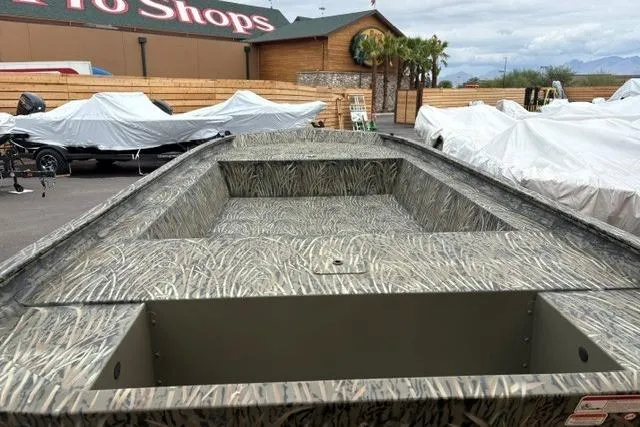 Slide: The Image of 2026 Tracker Grizzly 1754 Utility boat with camouflage design at outdoor showroom. - 20