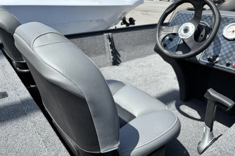 Slide: The Image of 2026 Tracker Bass Tracker Classic XL boat interior with steering wheel and gray seats. - 3