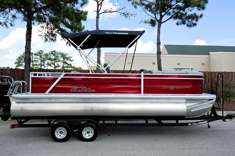 The Image of 2026 Sun Tracker Party Barge 22 RF DLX pontoon boat with canopy on trailer. - 0