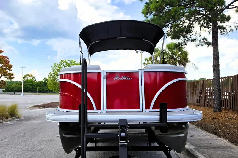 Slide: The Image of 2026 Sun Tracker Party Barge 22 RF DLX pontoon boat in a parking lot. - 8