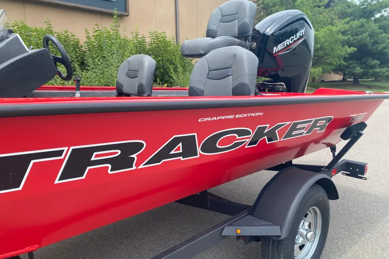 Slide: The Image of 2026 Tracker Pro Team 175 Crappie Edition boat with Mercury engine, red exterior. - 3