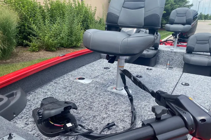 Slide: The Image of 2026 Tracker Pro Team 175 Crappie Edition boat interior with gray seating and fishing equipment. - 2