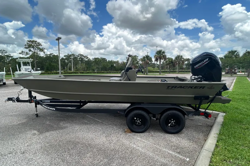 The Image of 2026 Tracker Grizzly 2072 CC boat on trailer, parked outdoors under a cloudy sky. - 0
