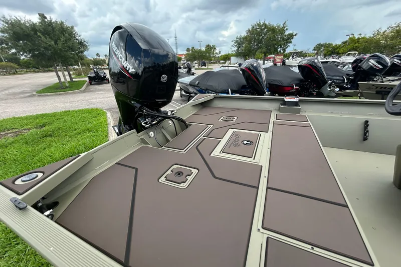 Slide: The Image of 2026 Tracker Grizzly 2072 CC boat with Mercury outboard motor, parked outdoors. - 9