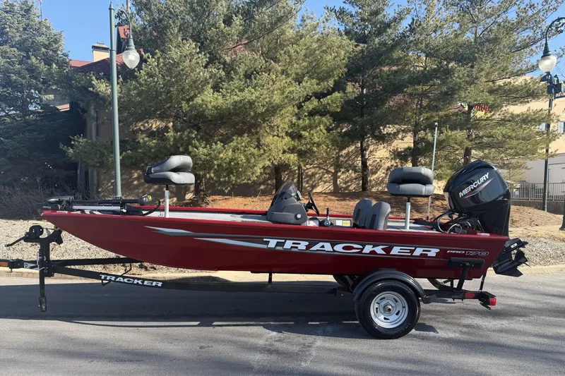 The Image of 2026 Tracker Pro 170 fishing boat on trailer, parked outdoors with trees in background. - 0
