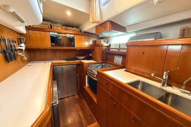 Slide: The Image of Luxurious wooden kitchen interior of a 2005 Beneteau 57 yacht with modern amenities. - 10