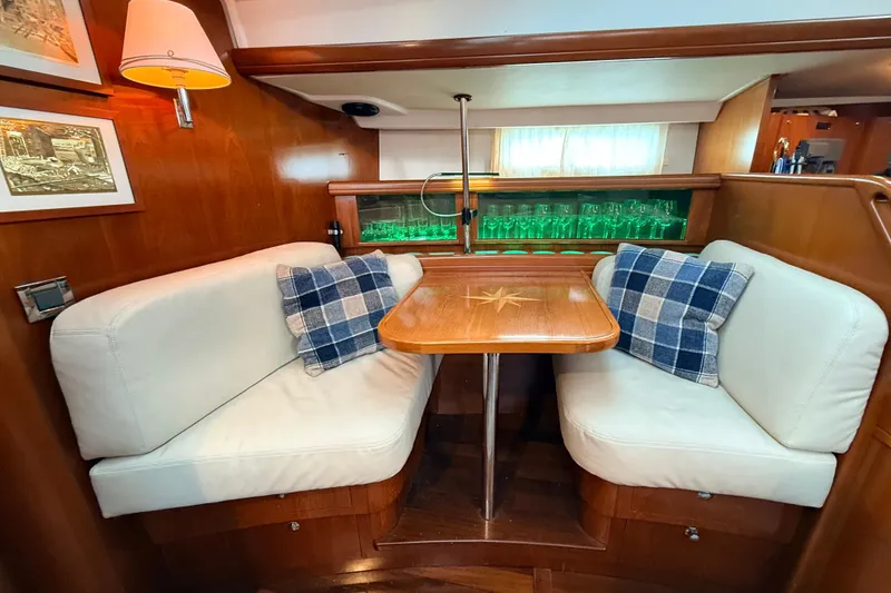 Slide: The Image of Luxurious interior of a 2005 Beneteau 57 yacht with cozy seating and elegant decor. - 9