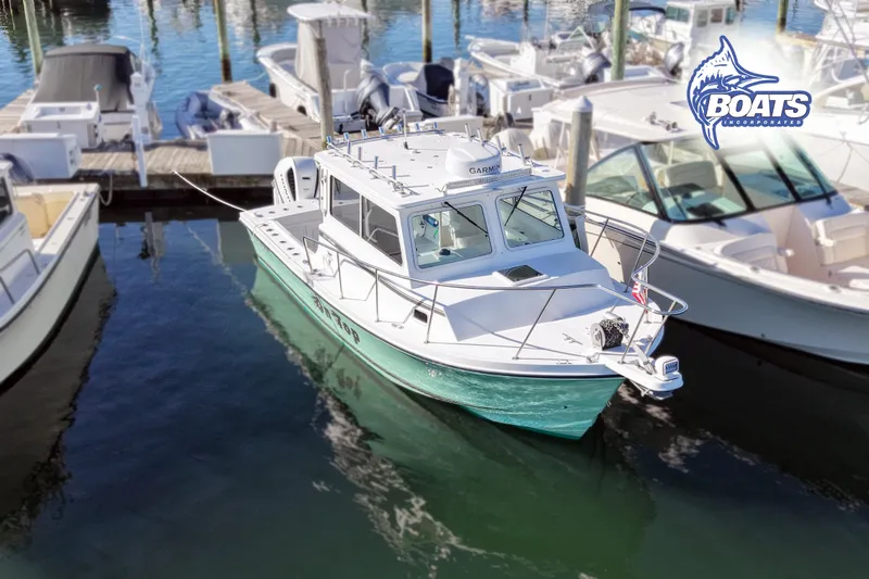 The Image of 2022 Steiger Craft 28 Miami boat docked at marina, surrounded by other vessels. - 0