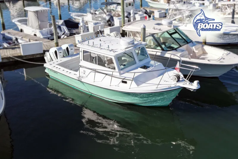The Image of 2022 Steiger Craft 28 Miami boat docked at marina, featuring sleek design and twin engines. - 0