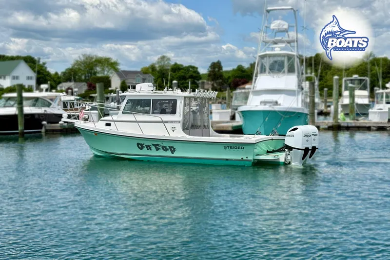 The Image of 2022 Steiger Craft 28 Miami boat docked in a marina, featuring twin Honda outboard engines. - 1