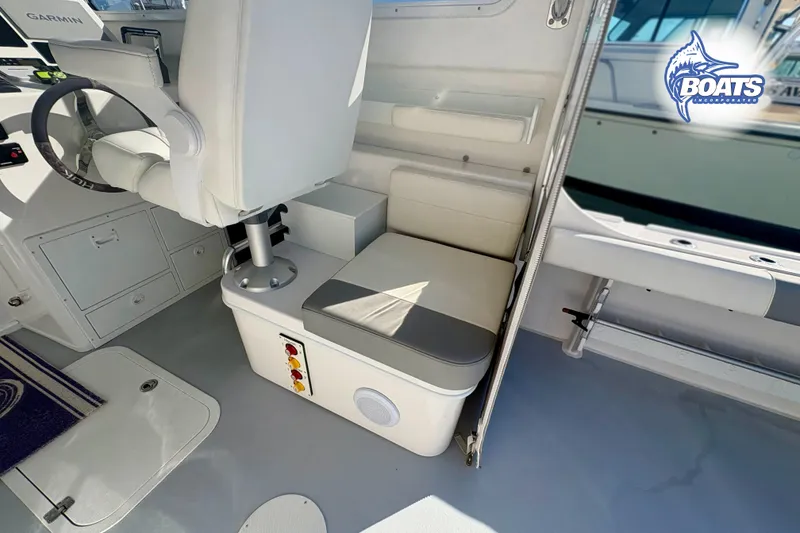 Slide: The Image of Interior of 2022 Steiger Craft 28 Miami boat, featuring helm seat and control panel. - 10