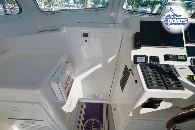 Slide: The Image of Interior of 2022 Steiger Craft 28 Miami boat with control panel and safety equipment. - 13