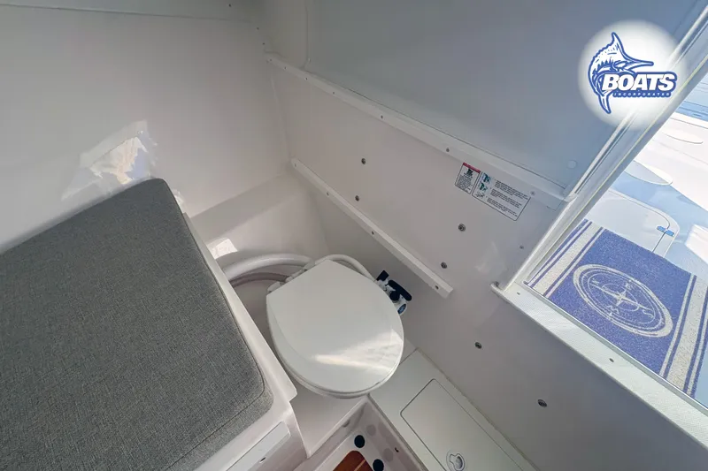 Slide: The Image of 2022 Steiger Craft 28 Miami boat interior with toilet and seating area. - 15