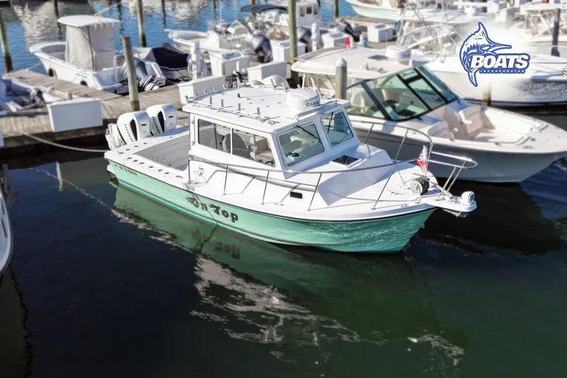 Slide: The Image of 2022 Steiger Craft 28 Miami boat docked at marina, featuring twin engines and sleek design. - 3