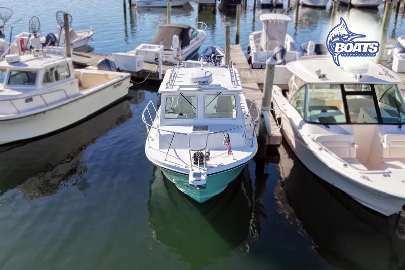 Slide: The Image of 2022 Steiger Craft 28 Miami boat docked at marina, surrounded by other vessels. - 4