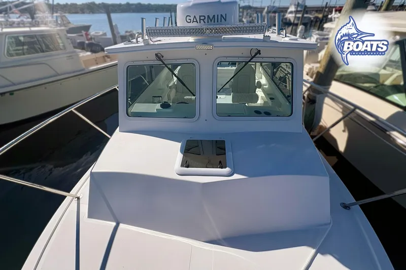 Slide: The Image of 2022 Steiger Craft 28 Miami boat docked, featuring Garmin equipment and Boats Incorporated logo. - 6