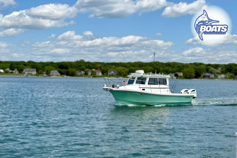 Slide: The Image of 2022 Steiger Craft 28 Miami boat cruising on a serene lake under a blue sky. - 3