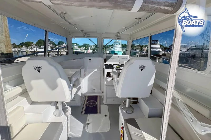 Slide: The Image of Interior of 2022 Steiger Craft 28 Miami boat with white seating and navigation equipment. - 8