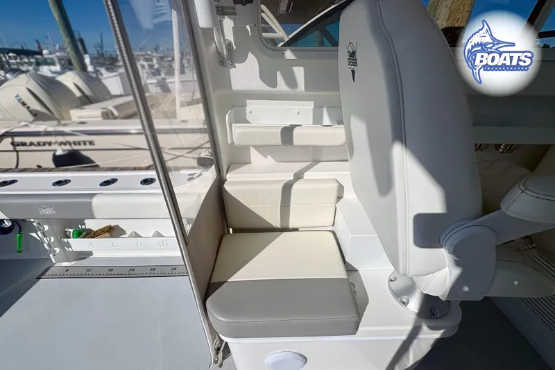 Slide: The Image of 2022 Steiger Craft 28 Miami boat interior with seating and fishing rod holders. - 9