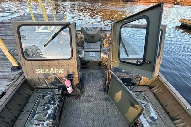 Slide: The Image of 2019 SeaArk Predator 220 AK SC boat interior with camouflage design and open doors. - 11
