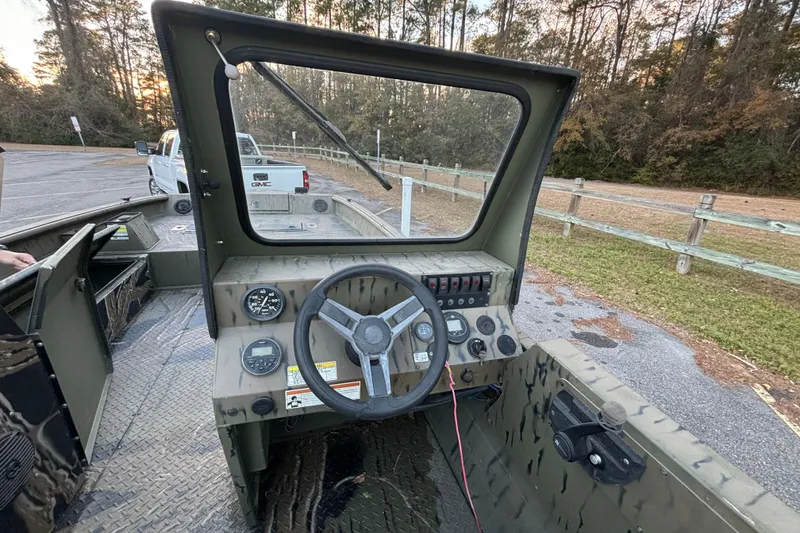 Slide: The Image of 2019 SeaArk Predator 220 AK SC boat dashboard with steering wheel and controls. - 14