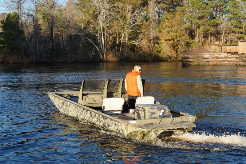 Slide: The Image of 2019 SeaArk Predator 220 AK SC boat cruising on a scenic river. - 7