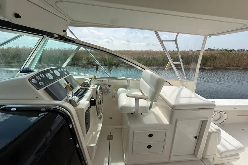 Slide: The Image of 2001 Pursuit 3400 Express boat cockpit with steering wheel and control panel. - 13