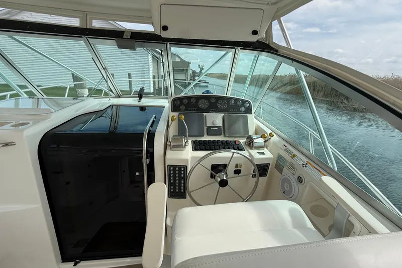 Slide: The Image of 2001 Pursuit 3400 Express boat cockpit with steering wheel and control panel. - 14