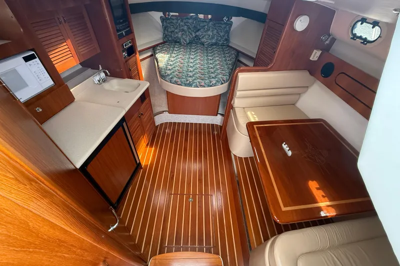 Slide: The Image of Interior view of 2001 Pursuit 3400 Express boat cockpit with clear windshield and control panel. - 18