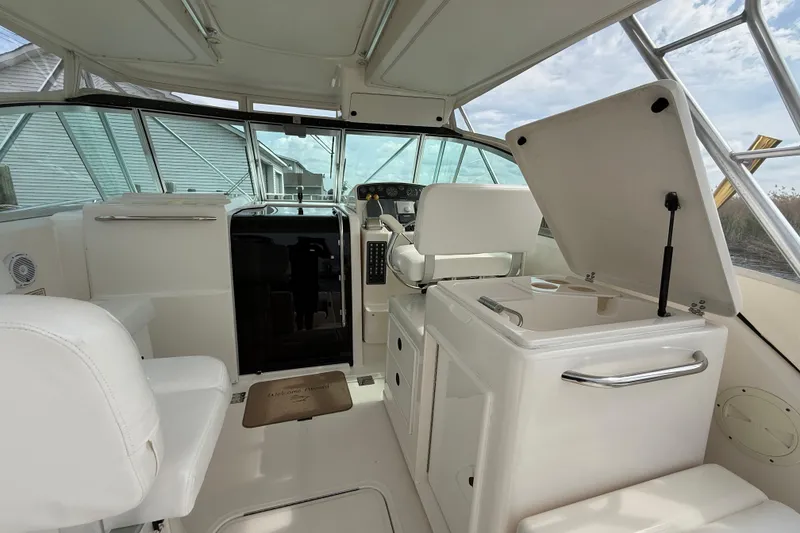 Slide: The Image of 2001 Pursuit 3400 Express boat interior with helm, seating, and storage compartments. - 20