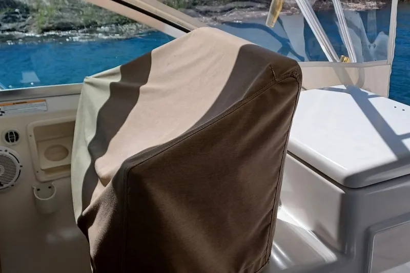 Slide: The Image of Shower area in 2001 Pursuit 3400 Express boat, featuring chrome fixtures and white curtain. - 27