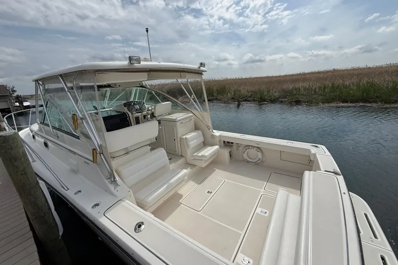 Slide: The Image of 2001 Pursuit 3400 Express boat interior with beige seating and white deck. - 28