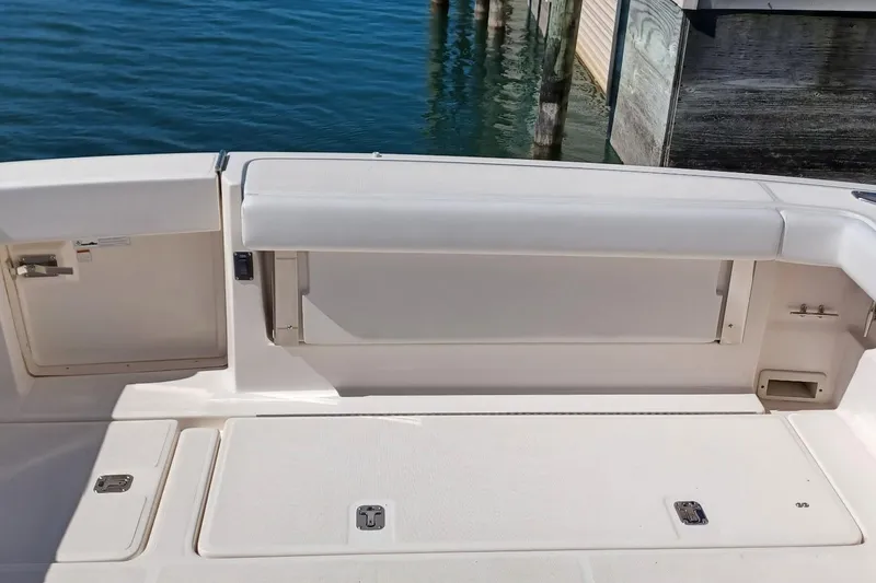 Slide: The Image of Tan canvas cover on a 2001 Pursuit 3400 Express boat seat. - 29