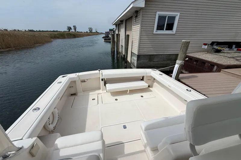Slide: The Image of 2001 Pursuit 3400 Express boat cockpit with protective covers and control panel. - 30