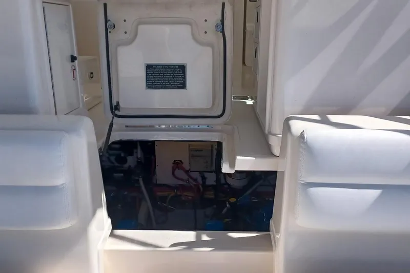 Slide: The Image of 2001 Pursuit 3400 Express engine compartment with open hatch and visible components. - 32