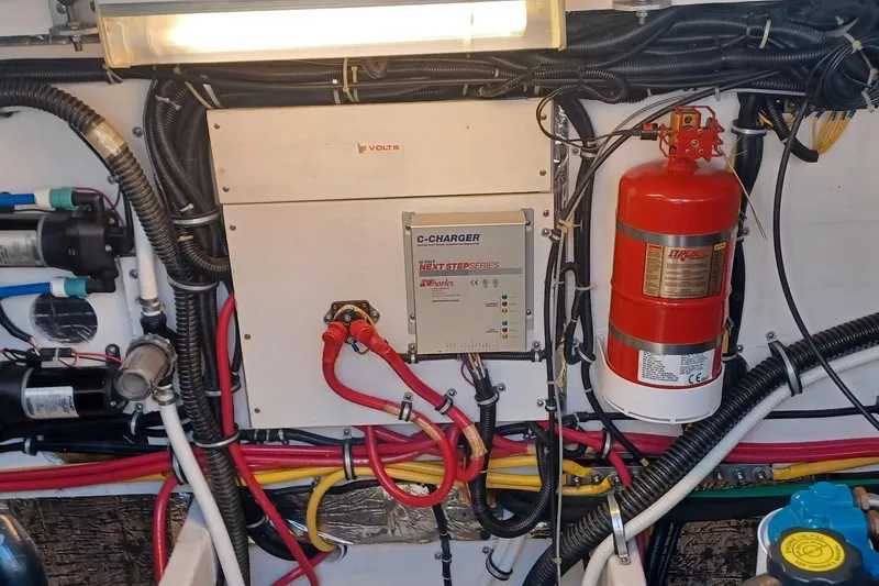 Slide: The Image of Engine compartment of a 2001 Pursuit 3400 Express boat with wiring and fire extinguisher. - 34