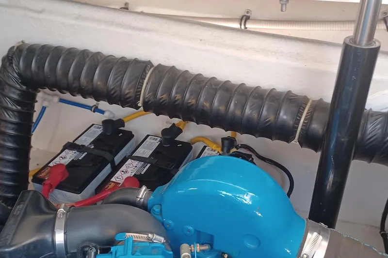 Slide: The Image of Engine compartment of a 2001 Pursuit 3400 Express boat with batteries and ventilation hose. - 35