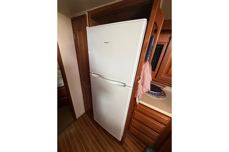 Slide: The Image of White refrigerator in the kitchen of a 1989 Viking 41 Convertible boat. - 16