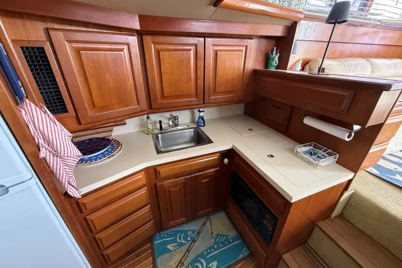 Slide: The Image of 1989 Viking 41 Convertible yacht kitchen with wooden cabinets and compact design. - 15