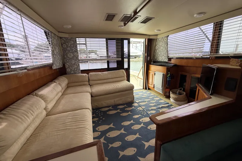 Slide: The Image of Luxurious interior of 1989 Viking 41 Convertible yacht with beige sofa and nautical decor. - 12