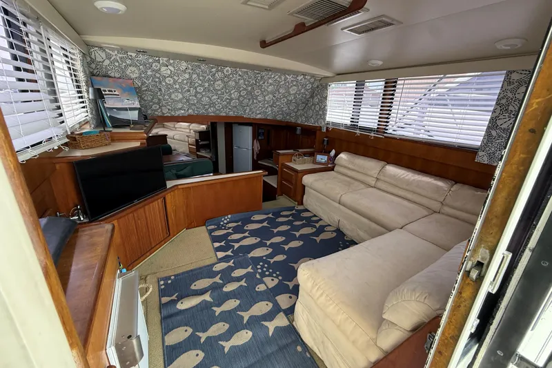 Slide: The Image of Interior of 1989 Viking 41 Convertible yacht with cozy seating and nautical decor. - 11
