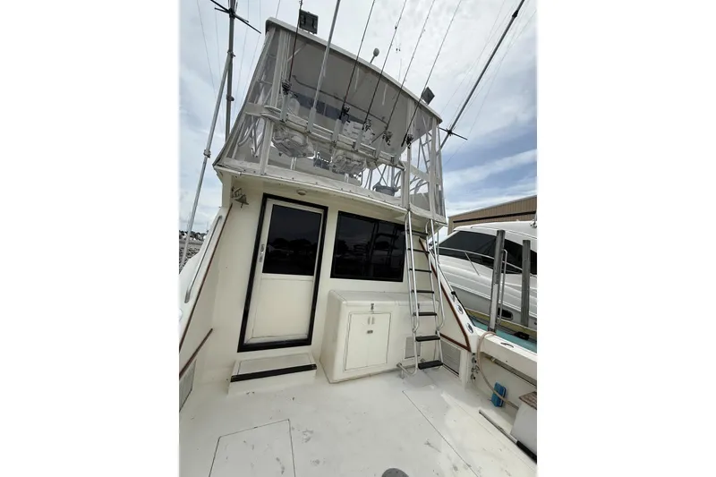 Slide: The Image of 1989 Viking 41 Convertible boat with flybridge and ladder, docked at marina. - 6