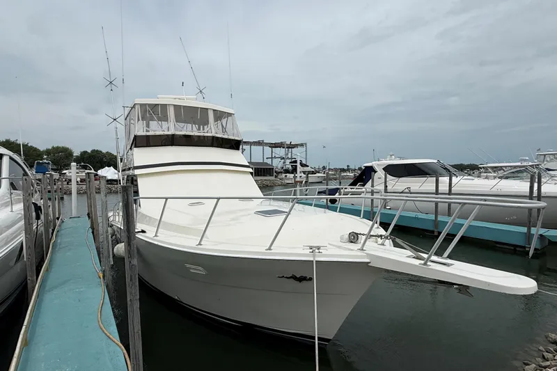 Slide: The Image of 1989 Viking 41 Convertible yacht docked at marina, overcast sky. - 1