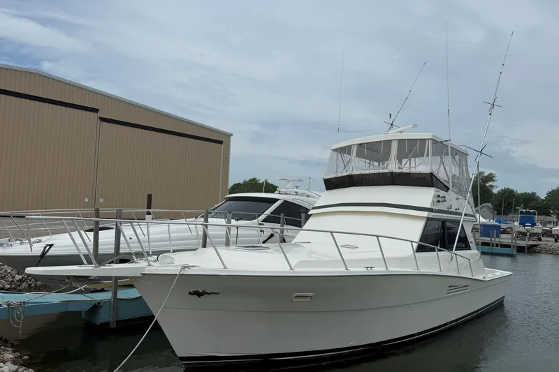 Slide: The Image of 1989 Viking 41 Convertible yacht docked at marina, featuring sleek design and spacious deck. - 2