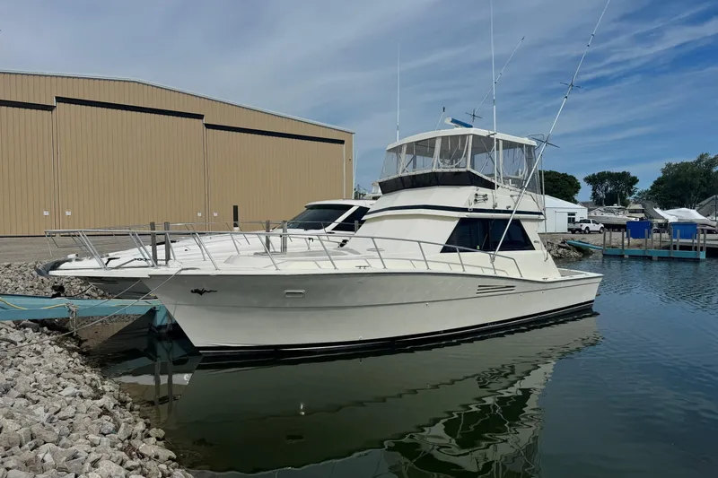 The Image of 1989 Viking 41 Convertible yacht docked near a large warehouse. - 0