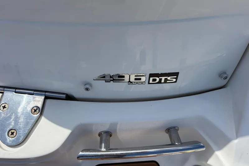 Slide: The Image of Close-up of a 2008 Sea Ray 270 Sundeck boat with 496 MAG DTS emblem. - 12