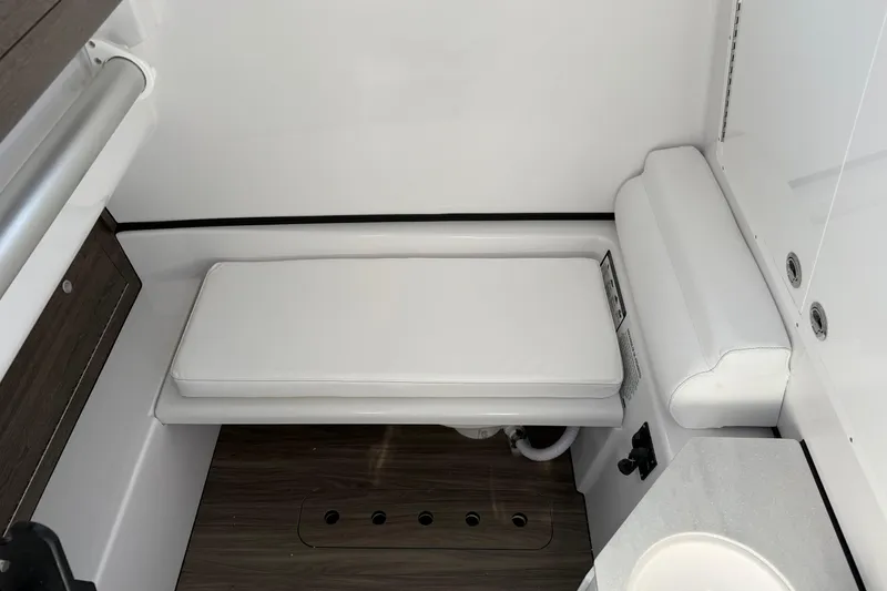Slide: The Image of Interior of 2026 Sportsman Open 322 Center Console boat, featuring white cushioned seating. - 10