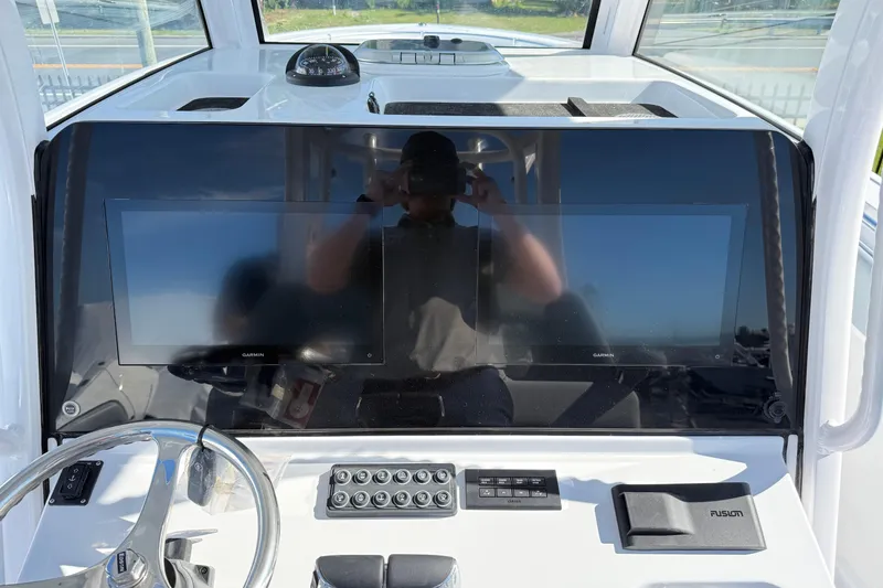 Slide: The Image of 2026 Sportsman Open 322 Center Console dashboard with dual Garmin displays and steering wheel. - 11